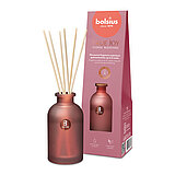 Ein Raumduft-Diffuser mit Rattanstäbchen aus grünem Milchglas mit der Duftrichtung "Botanic Freshness". Im Hintergrund ist die Verpackung des Artikels mit Bolsius Schriftzug zu sehen.